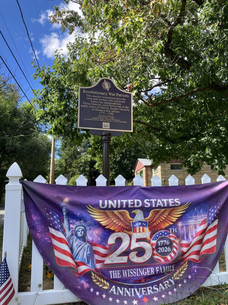 Fence showing banner and plaque